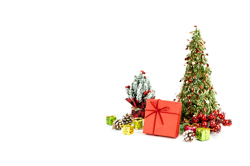 Red gift box with Decorated Christmas Tree isolated on white background.