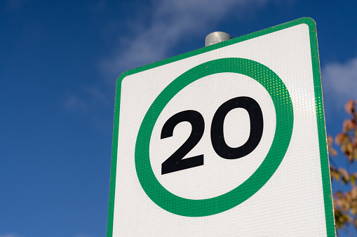 A 20mph speed warning sign, with the number 20 in a green circle.