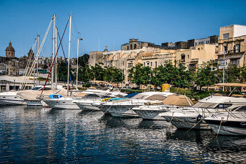 Cityscape of Monaco at sunset. Sea port with moored yachts, residential buildings and streets with illumination