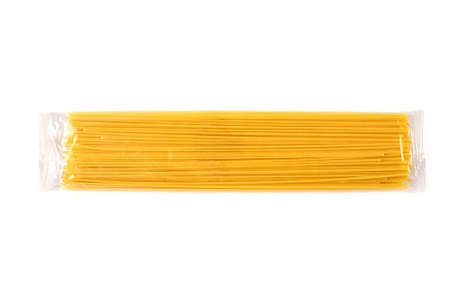 Variety of types, colors and shapes of Italian pasta in white wooden box. Top view, with copy space