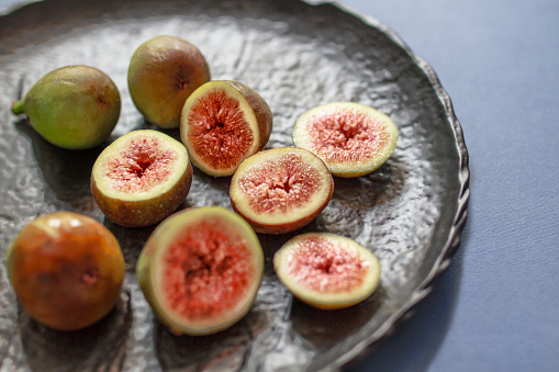 purple figs and leaves isolated on white background. fruit collection.