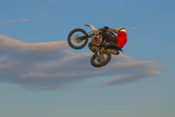 Kyiv, Ukraine - July 19, 2023: Public training in a city public park. No entrance tickets required. An unknown biker improves his high jumping skills. Unusual motorcycle control combined with a risky jump into the air. Park coordinates on Google map 50.492544, 30.544535 (50°29'33.2\