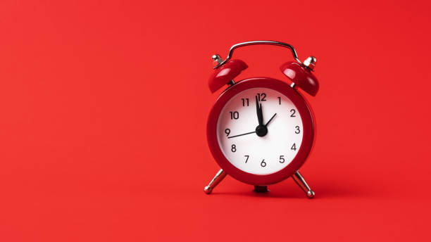 istock A classic red alarm clock stands out boldly against a monochromatic red background. 1782066548