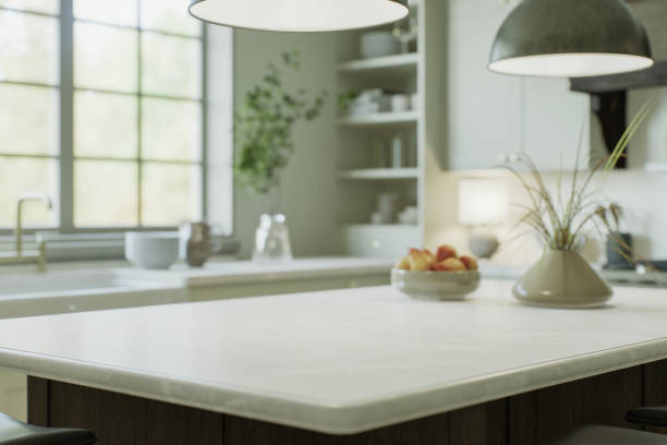 istock Kitchen interior with an island with a white stone countertop - for placing and advertising products against the blurred background of the kitchen by the window. 3D rendering 1782071015