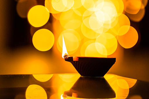Clay Diya lamp lit during Diwali festival