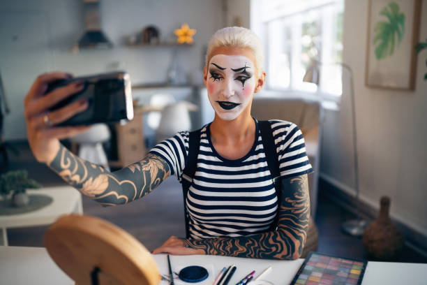 istock Young woman, a mime artist, taking selfies at home while getting ready for pantomime show. 1782079613