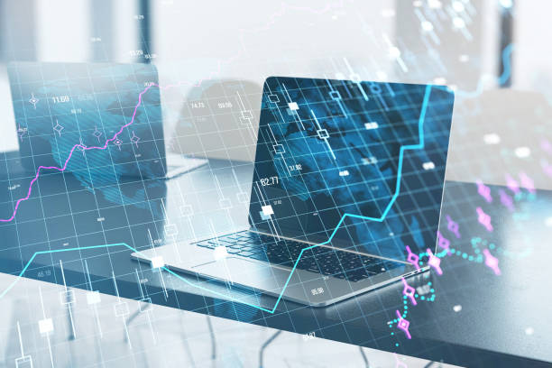 istock Close up of laptop computer on office desk with glowing forex chart and grid on blurry background. Stock, financial growth and trade concept. Double exposure. 1782079659