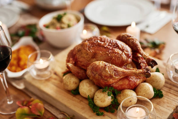 istock Thanksgiving, celebration and a roast chicken on a table in the dining room from above for holiday. Food, meat and turkey with a meal or dinner feast in home for a social event or american tradition 1782080802