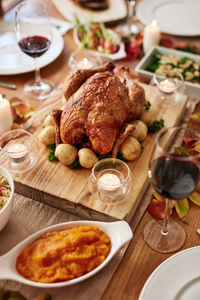 istock Thanksgiving feast, tradition and a chicken on a table in the dining room from above for celebration. Food, meat and roast turkey with a gourmet meal in a home for a social event or american holiday 1782080808