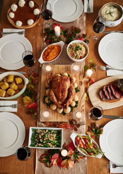 istock Thanksgiving roast, celebration and a chicken on a table in the dining room from above for tradition. Food, feast and turkey with a gourmet meal in a home for a social event or american holiday 1782080809