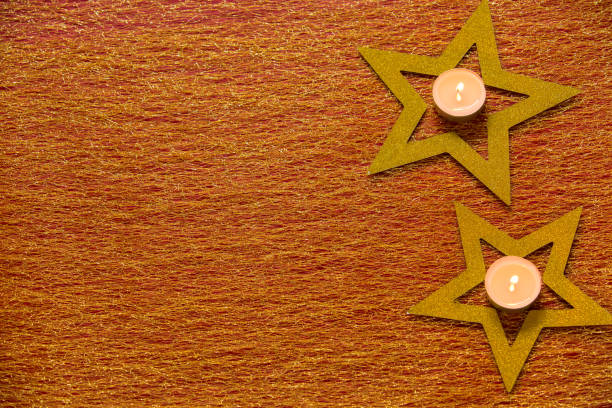 Christmas background with dolden stars and candle
