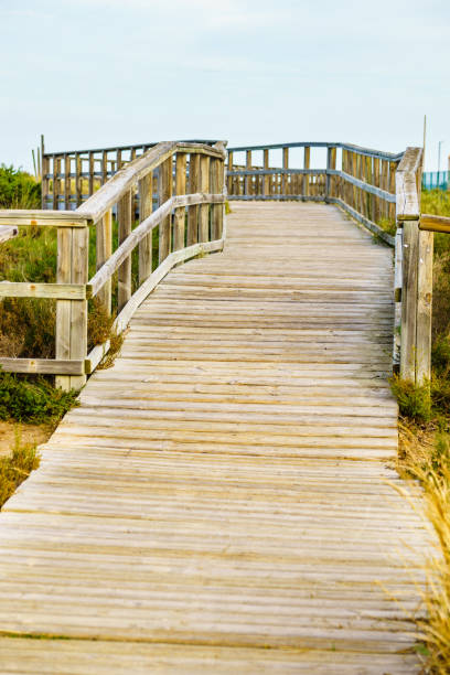 istock Wooden path to beach sea water. 1782084457