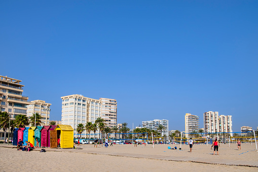 Young people playing volleyball on the Playa de San Juan, a 3km long strip of golden sand in the municipal area of Alicante, a city and a tourist destination on the Costa Blanca