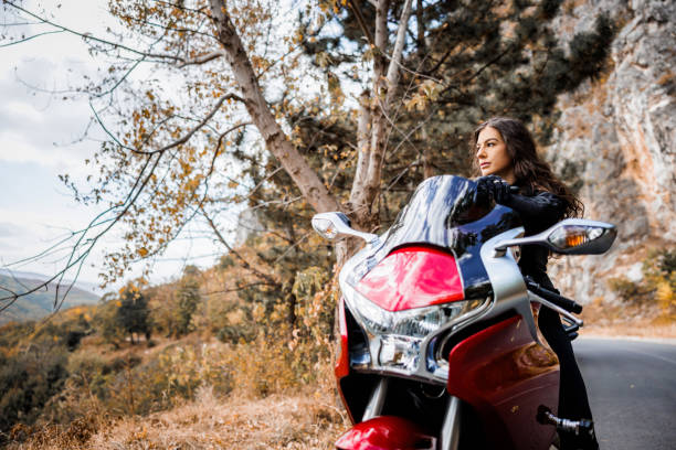 istock Beautiful woman enjoys nature while rests from motorcycle ride 1782091579