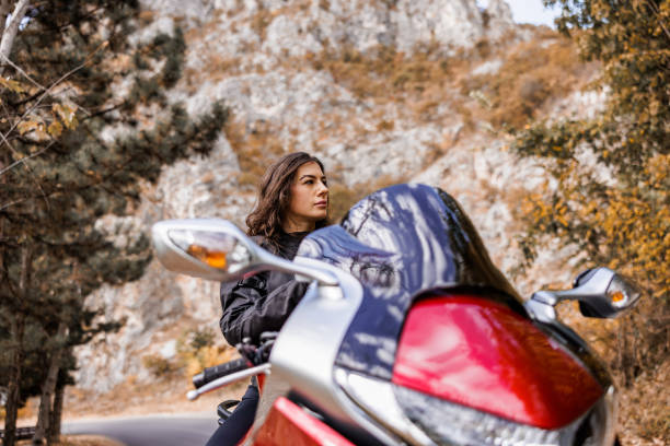 Female biker take a break from motorcycle ride
