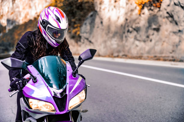 istock Female biker on the road prepares to start ride 1782093341