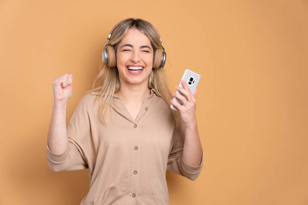 istock joyful woman dancing with headphones 1782095605