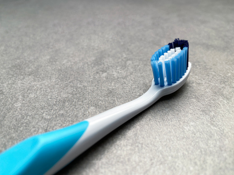 Toothbrush on granite tile background with copy space