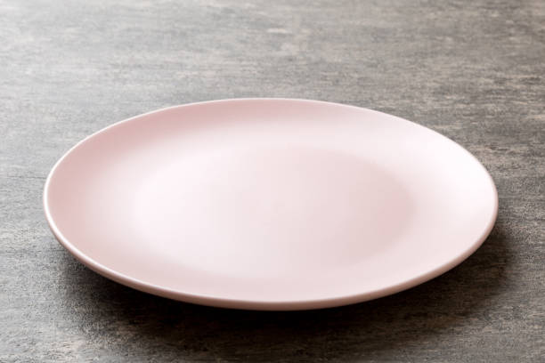 istock Perspective view of empty pink plate on cement background. Empty space for your design 1782100040