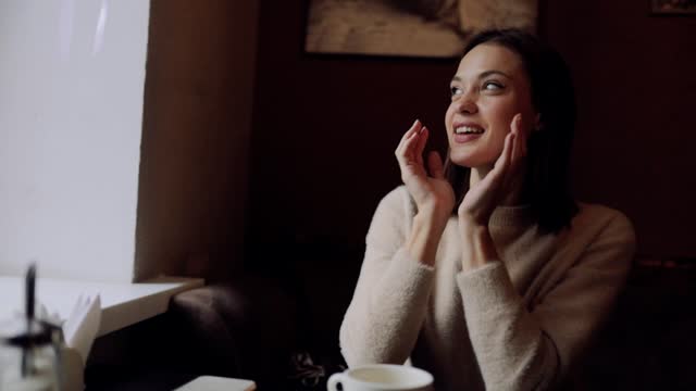 beautiful woman in a cafe drinks coffee with pleasure and enjoys the taste.