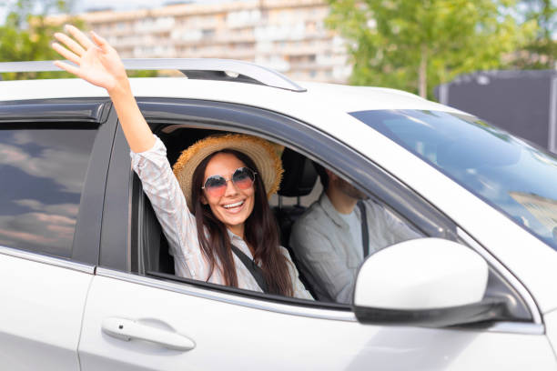 istock Carefree pretty lady waving from open car window 1782123983