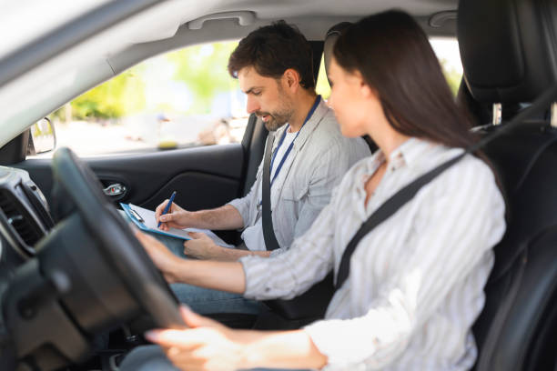 istock Handsome young man instructor examining woman driver 1782124012