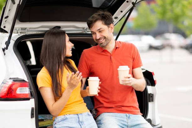 istock Loving millennial couple have break during road trip, drinking coffee 1782124029
