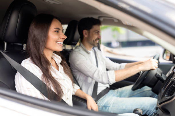istock Cheerful millennial couple test drive new auto together 1782124566