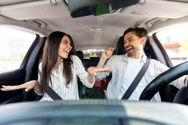 istock Funky cheerful couple having fun while going somewhere by car 1782124572