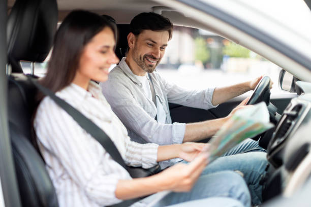 istock Happy millennial couple having car trip together, reading map 1782125151