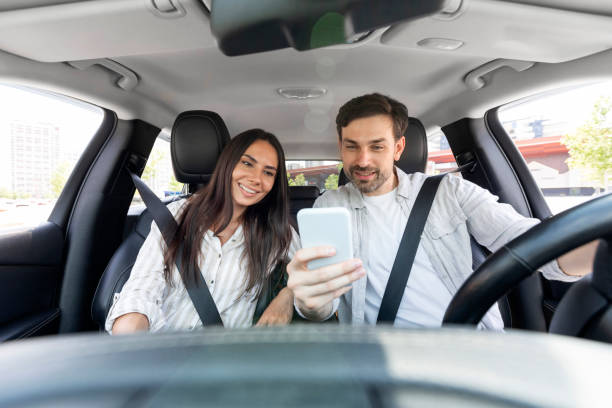 istock Happy millennial couple having car trip together, using cell phone 1782125172