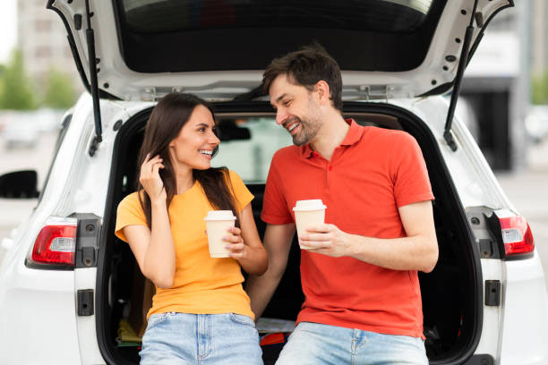 istock Cheerful millennial couple have break during road trip, drinking coffee 1782125217