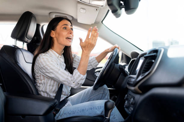 istock Woman driver stuck in traffic jam gesturing with hand, screaming 1782125233