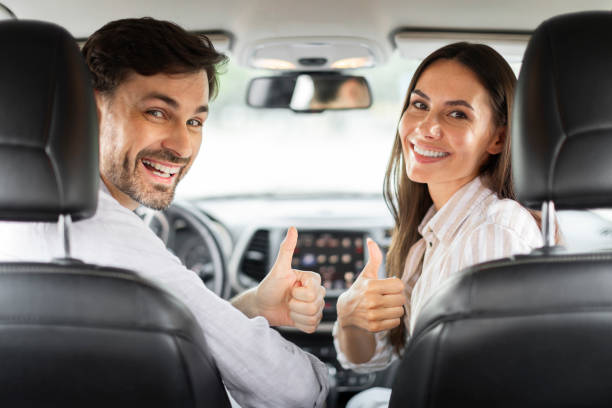 istock Back view happy couple showing high five, sitting in car 1782125249