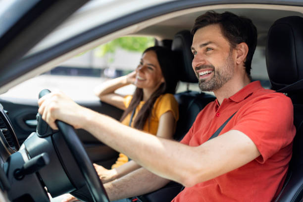 istock Beautiful happy young couple sitting on front seats and smiling 1782125507