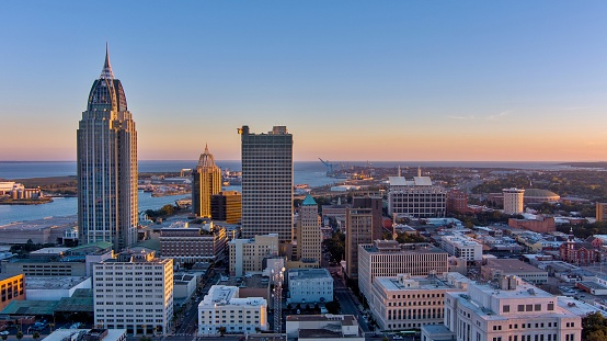 Drone shot of the downtown Mobile, Alabama waterfront skyline at sunset