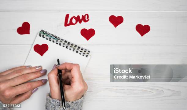 Womans Hands Write A Love Letter On Notepad Romantic Greeting For Valentines Day Valentines Day Holiday Concept Top View Flatlay Copy Space Stock Photo - Download Image Now