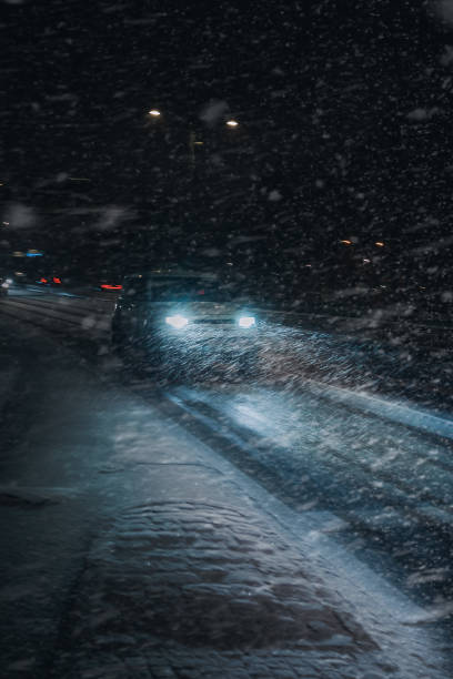 istock Snowy night time car driving 1782158290