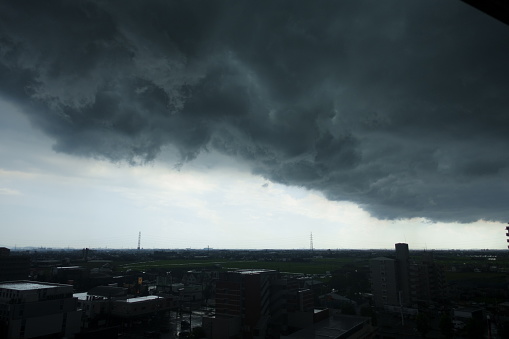 The cityscape darkens due to dark clouds.