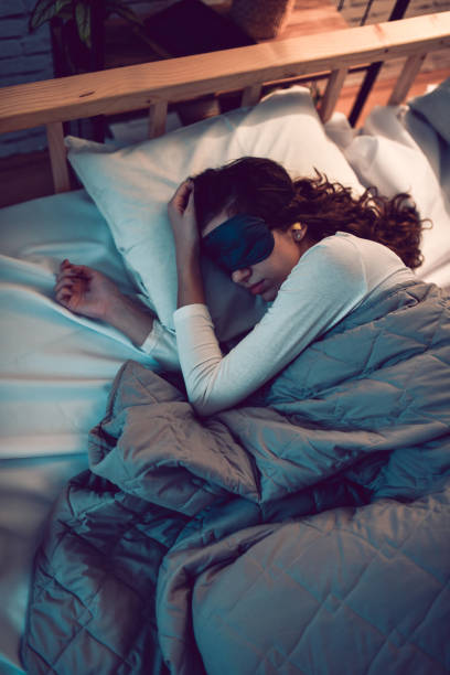 istock Female Addressing Her Sleep Problems With Eye Mask And Ear Plugs 1782166541