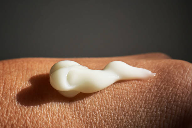 istock A smear of white moisturizer or sunscreen on a woman's hand. 1782168620