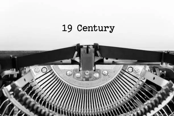 Photo of 19 century word closeup being typing and centered on a sheet of paper on old vintage typewriter mechanical