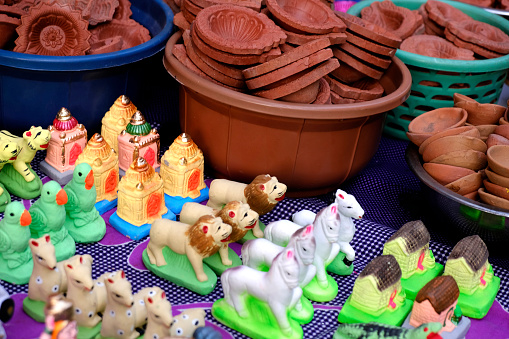 Pune, India, In Maharashtra children build mud forts as an homage to Chhatrapati Shivaji Maharaja, and decorate it with small warrior statues made of soil, which are sold in the market before Diwali.