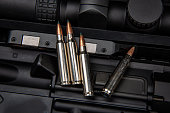Close-up of .223 carbine cartridges. Dark background.