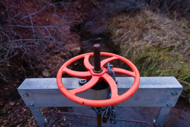 Round Colorful Valve Controlling Flow on Creek - Water rights diversion dam area with vivd colorful round valve detail.