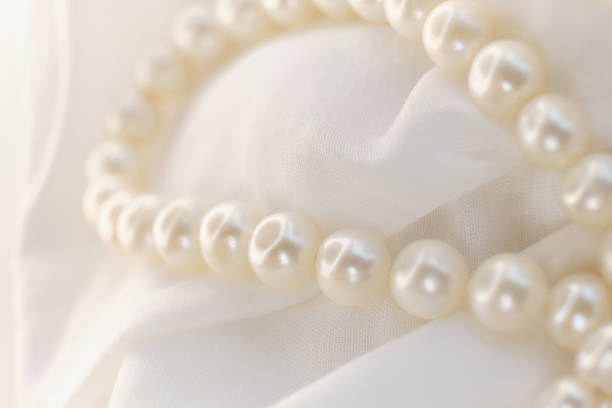 istock Pearls softly resting on a white background exhibit a calm, undisturbed elegance. This imagery is a comforting break from the high-energy, over-saturated visuals of modern digital trends. 1782202362