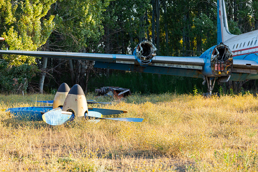 Bishkek, Kyrgyzstan - September 26, 2023: Disassembled engines and propellers of the old soviet plane in the aircraft graveyard