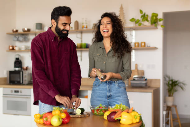 istock Attractive middle eastern spouses cooking together at home, making delicious meal talking and laughing, kitchen interior 1782208443