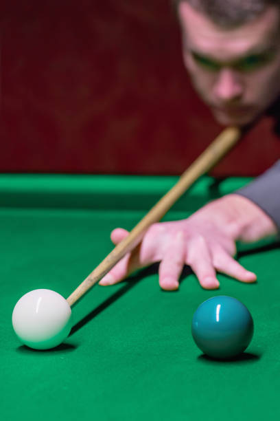 istock A snooker player demonstrates skill and precision while striking the ball. 1782215512