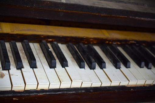 An old piano sits in an abandoned church building in rural Missouri, MO, United States, US, USA.